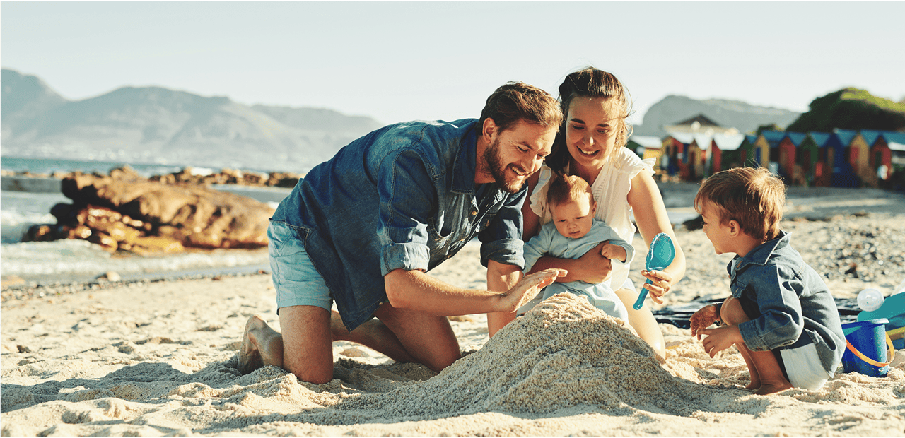 family playing at the beach