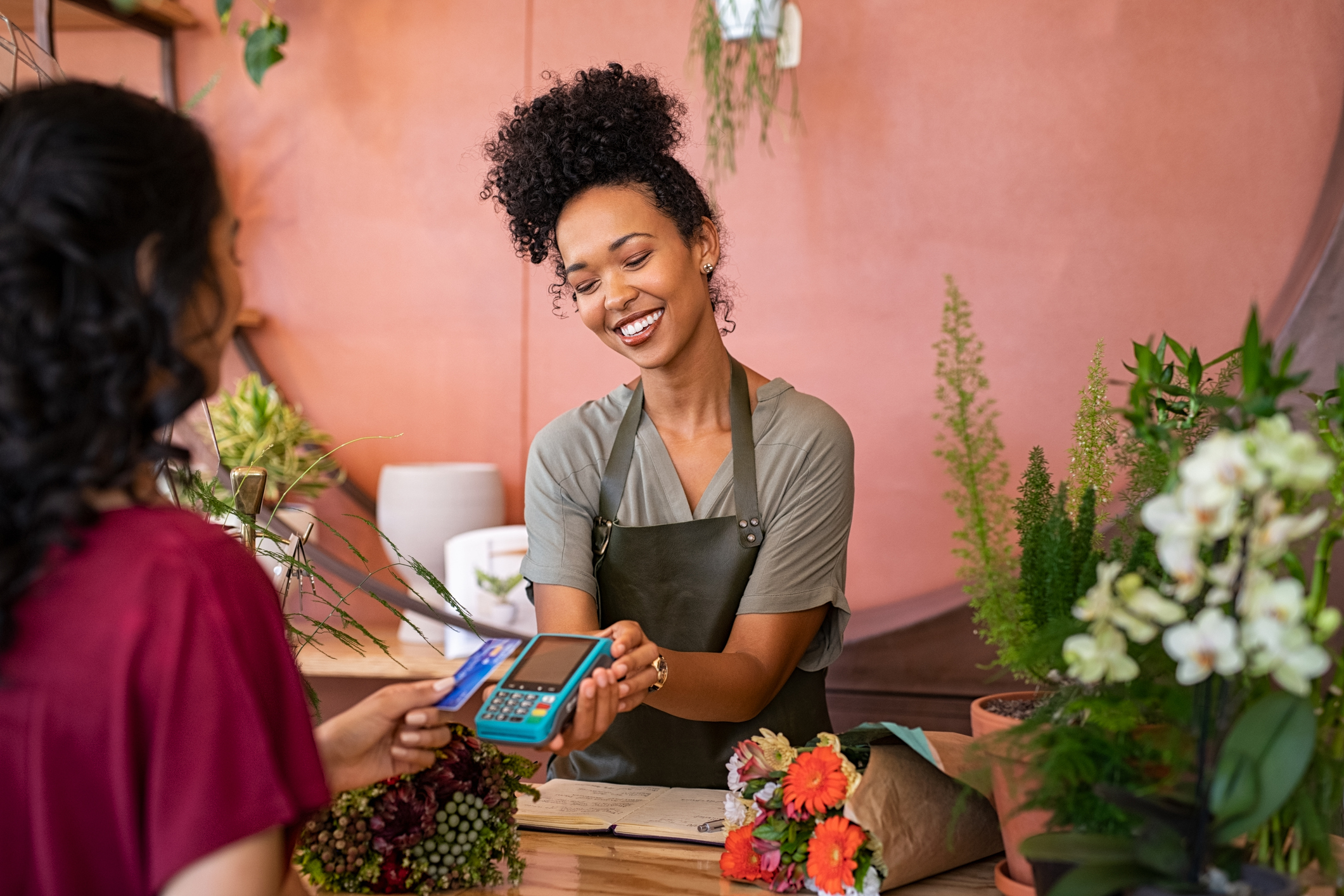 Customer paying with contactless card at flower shop